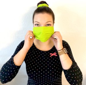 woman wearing neon green facemask white dots